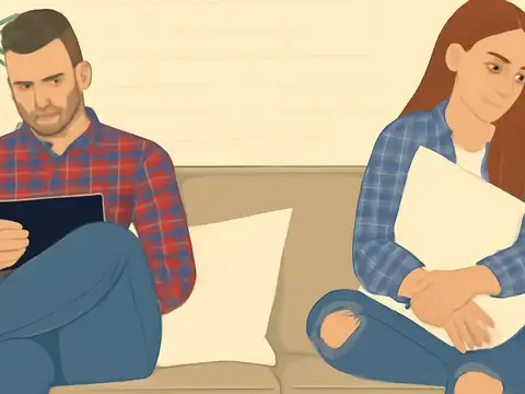 Flat vector illustration of a man and woman sitting apart on a sofa, the woman hugging a cushion and looking away.