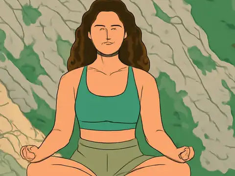Flat vector illustration of a person with long wavy brown hair sitting cross-legged with eyes closed and hands resting on their knees, in a green top and olive shorts, in front of a rocky green and beige background.
